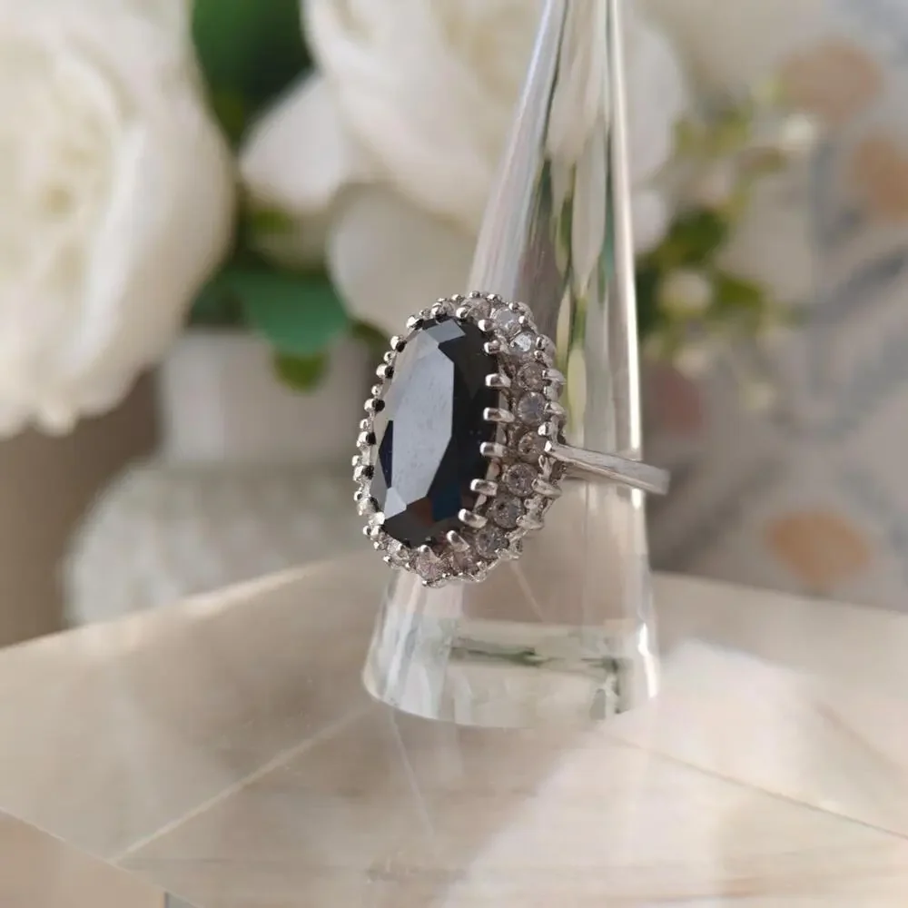 Silver tone oval black glass halo ring with white rhinestones